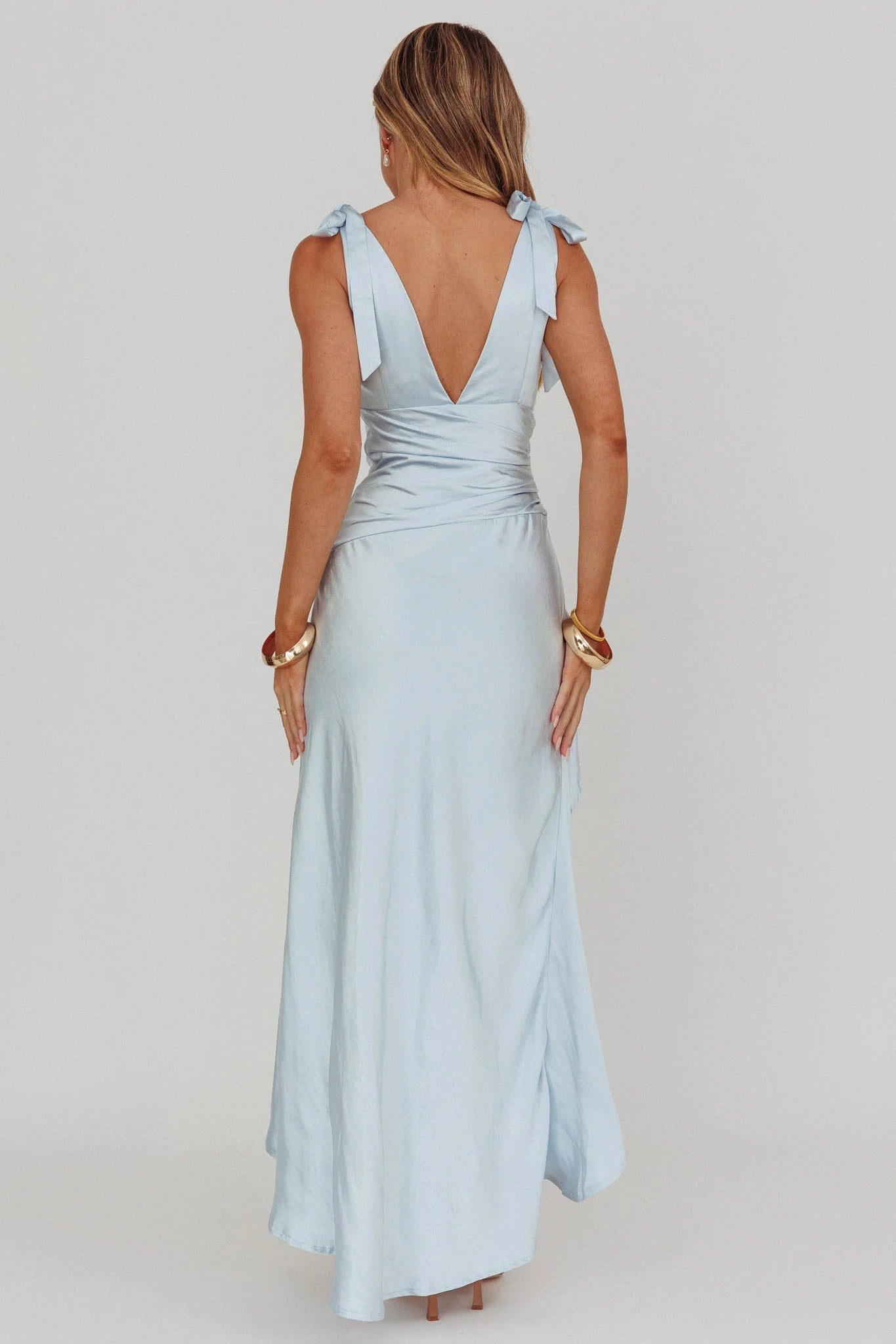 Vestido Weitese, sofisticado vestido largo de satén azul marino con escote en V pronunciado, tirantes con detalle de lazo y corte asimétrico.